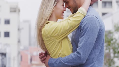 Side-view-of-Caucasian-couple-cuddling-in-the-street