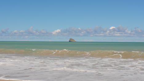 waves breaking on sandy beach isolated island view