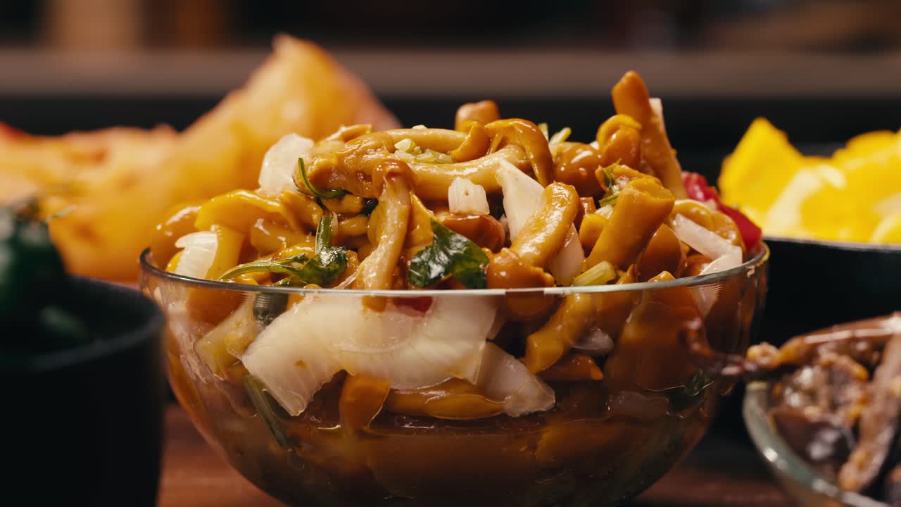 Close-up of fermented yellow honeydew mushrooms with onion in plate. Preservation of vegetables in glass jars. Fermentation preserved mushroom with spices.