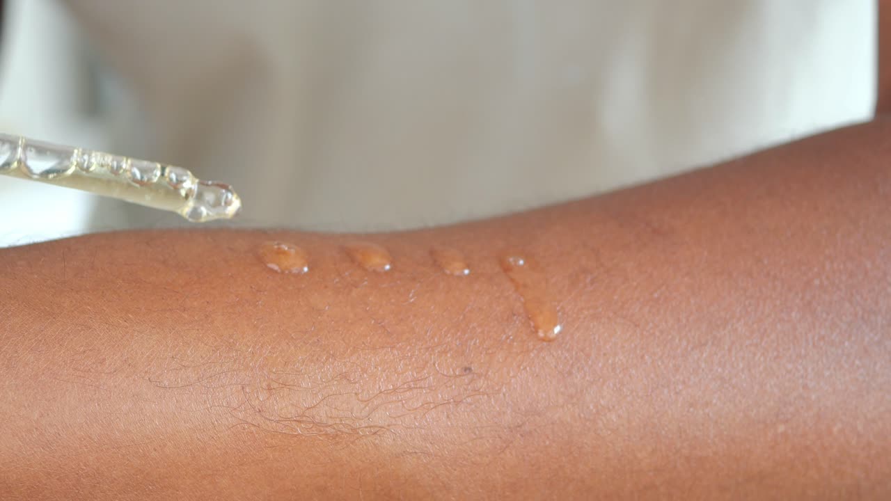 Applying skincare serum with a dropper onto skin