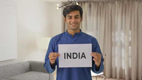 Happy-Indian-boy-holding-INDIA-banner