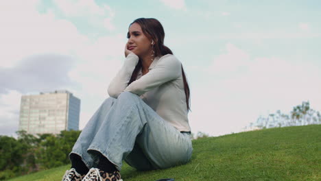 lonely woman sitting on grass