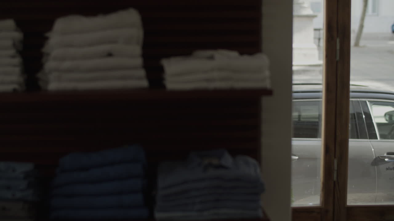 Black male couple window shopping, coming in clothing shop.