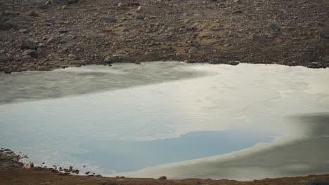 Cold-puddle-surrounded-by-tundra-rocks