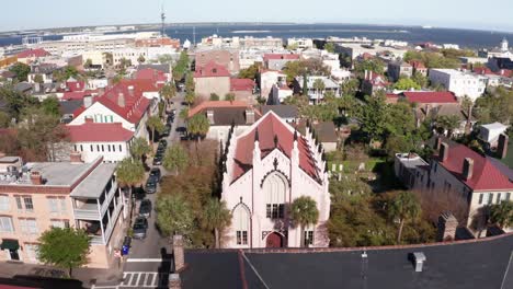 low push-in aerial shot of the ornate french huguenot church in charleston, south carolina