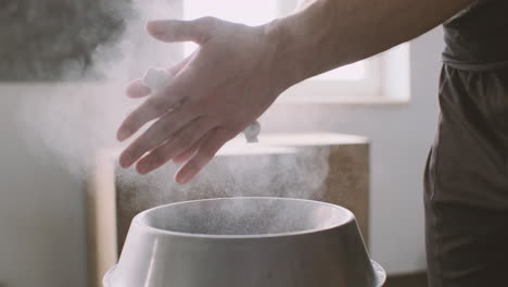 fitness man athlete hands taking chalk powder before training