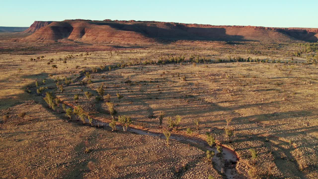 Aerial footage of a small creek and Kings Canyon, Watarrka. Northern Territory, Australia. August 2022