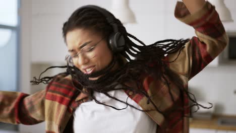 happy cool black girl having fun time dancing alone at home