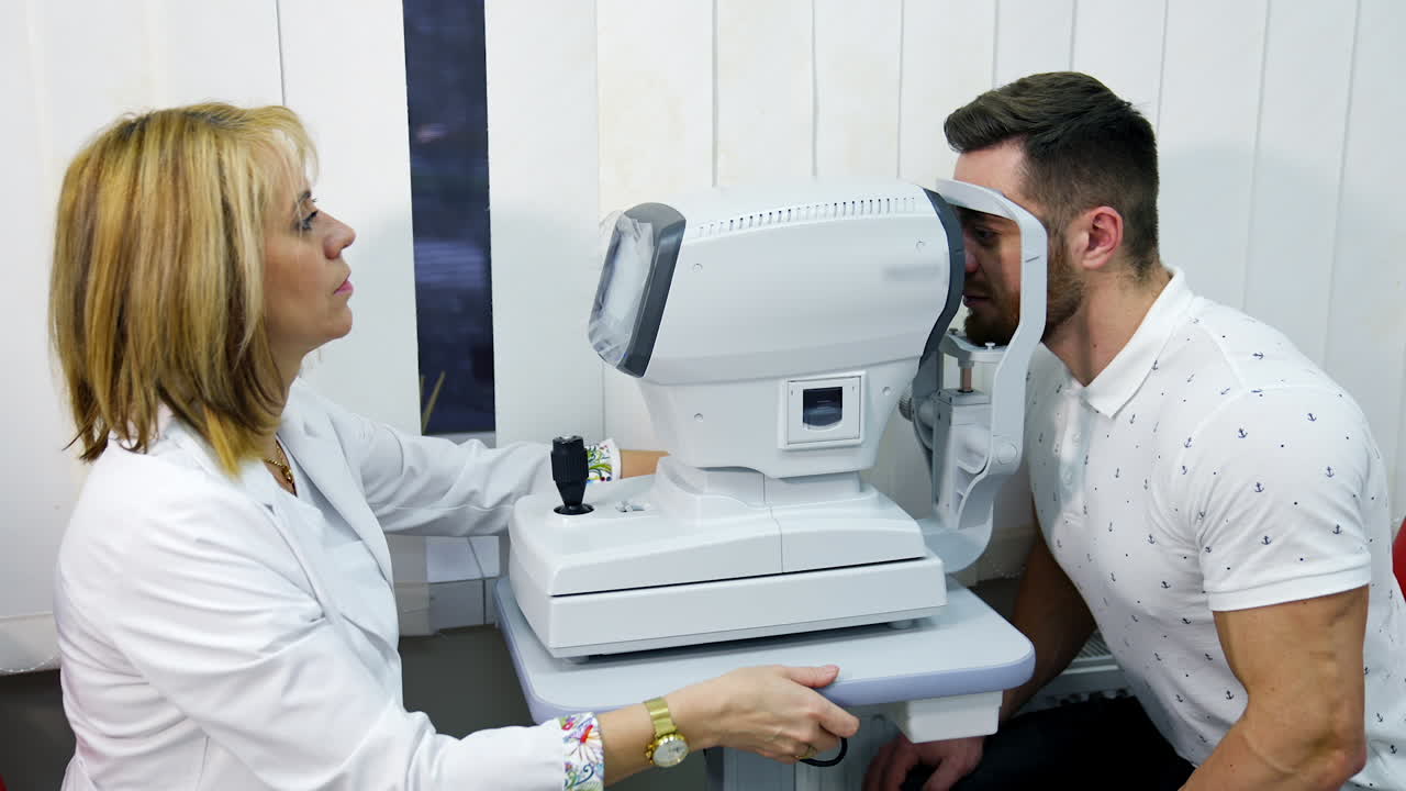 Patient in ophthalmology clinic. Handsome young man checking the eye vision in modern ophthalmology clinic