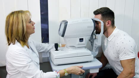patient in ophthalmology clinic. handsome young man checking the eye vision in modern ophthalmology clinic