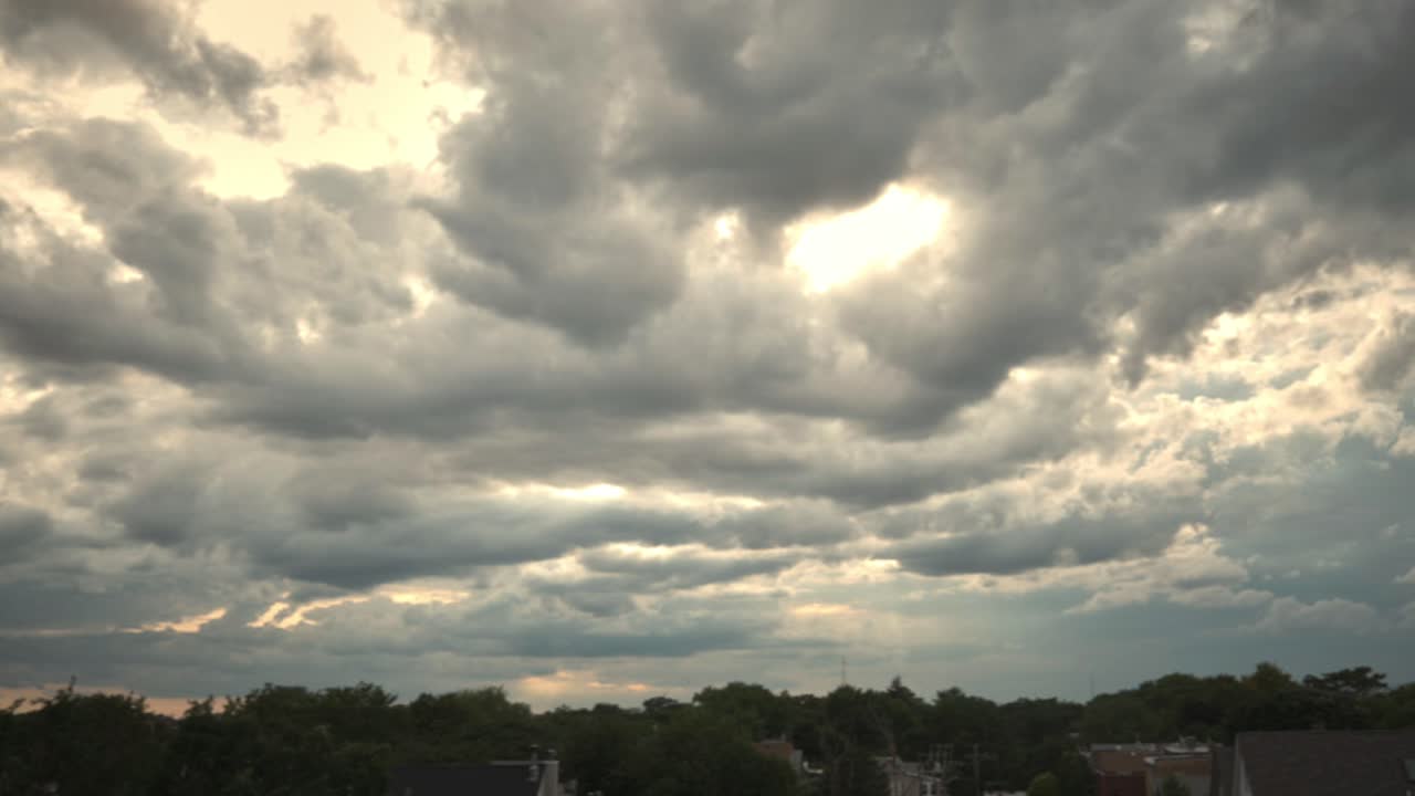 Time lapse of rolling clouds over urban tree tops in Chicago, IL  USA