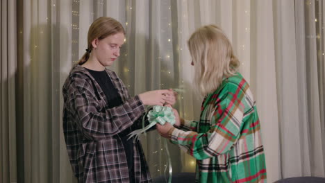 mother and daughter wrapping a gift together