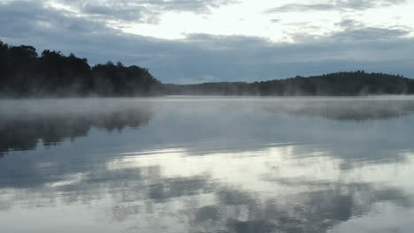 Toma-Estática-De-Humo-Y-Niebla-De-4k-Drones-En-La-Superficie-Del-Agua-De-Un-Lago