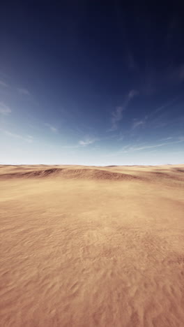 a vast desert landscape with blue sky and sand dunes