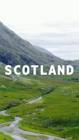 vertical video aerial drone shot of glen and countryside in uk with animated graphic spelling out scotland