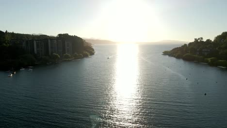 Panoramic-view-of-lake-villarrica-in-the-south-of-chile-with-the-sun-in-the-background---aerial