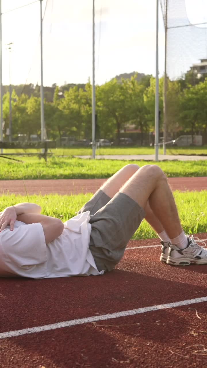 Man exercising on running track