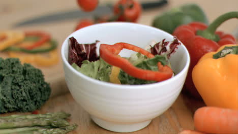 vegetables dropping into bowl in super slow motion