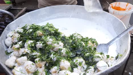 a closeup shot of super soft juicy dahi vada. indian tasty street food dahi vada
