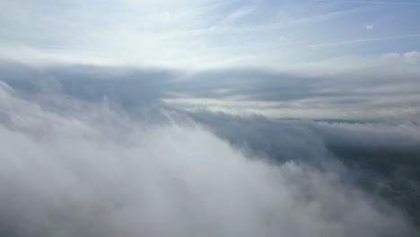 aerial view flying over a layer of textured clouds