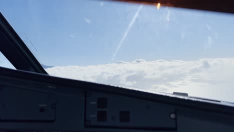 Pilots-view-of-an-aircraft-turning-in-flight-above-the-clouds