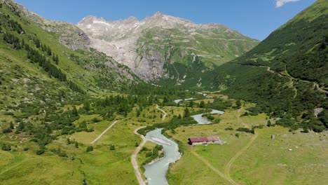aerial view of rhône river winding through picturesque goms valley, swiss alps