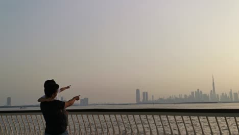 father and son enjoy sunset at dubai skyline