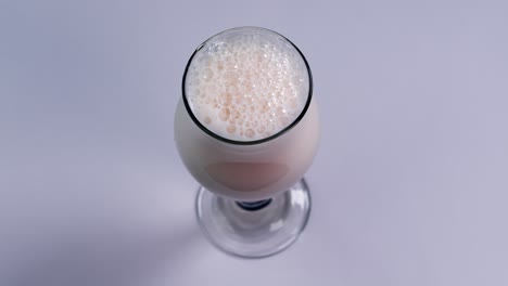 Beer-is-pouring-into-glass-on-white-background