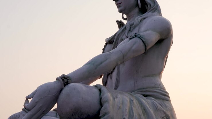 hindu god lord shiva statue in meditation posture with flat sky at evening from low angle video is taken at parmarth niketan rishikesh uttrakhand india on Mar 15 2022