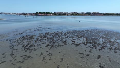 Drone-shot-flying-over-some-dirty-and-shallow-water-in-Portugal