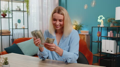 smiling businesswoman counting cash money dollar checking salary enjoy richness at office workplace
