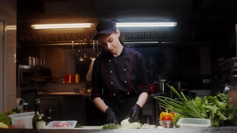 female chef preparing food in a restaurant kitchen