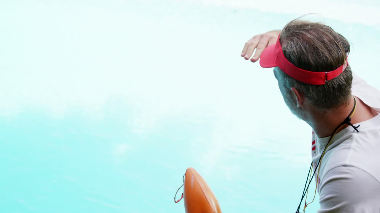 Lifeguard standing at pool side