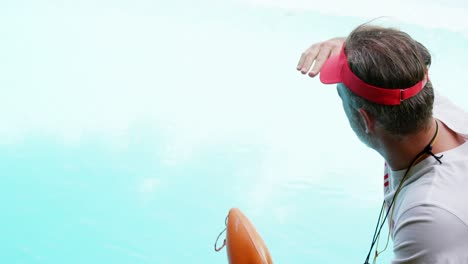 lifeguard standing at pool side