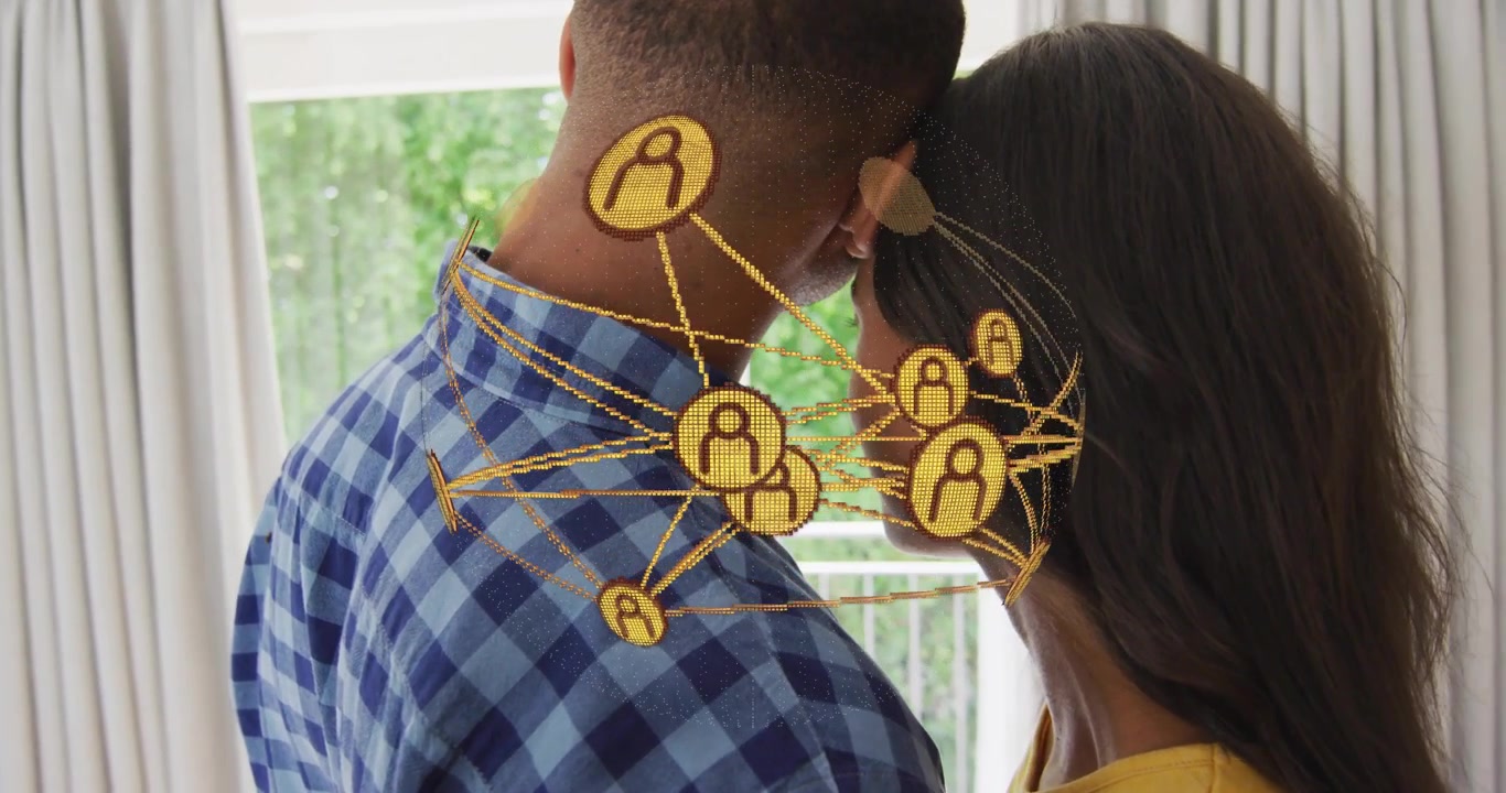 Man and woman touching heads by window, icons emerging rotating around them showing tech connection