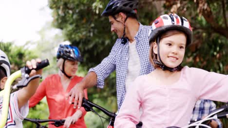 parents and childrens cycling in the park