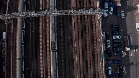 Pan-up-aerial-drone-shot-of-trains-entering-central-London-bridge-station-shard