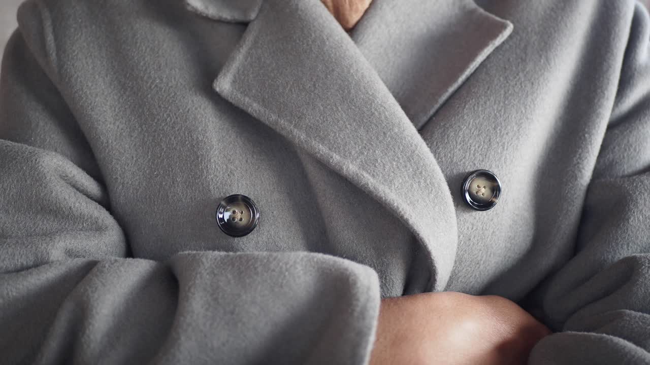 Close-up of a woman's grey wool coat