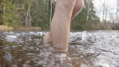 slow motion - ice bathers feet closeup leaving an icy lake