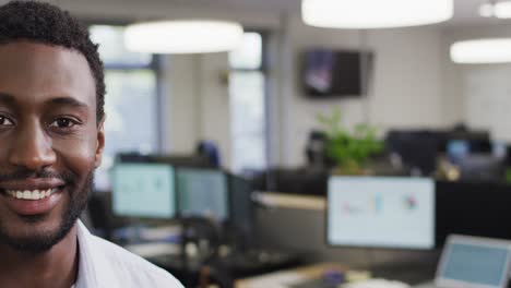 Portrait-of-happy-african-american-businessman-in-office,-slow-motion