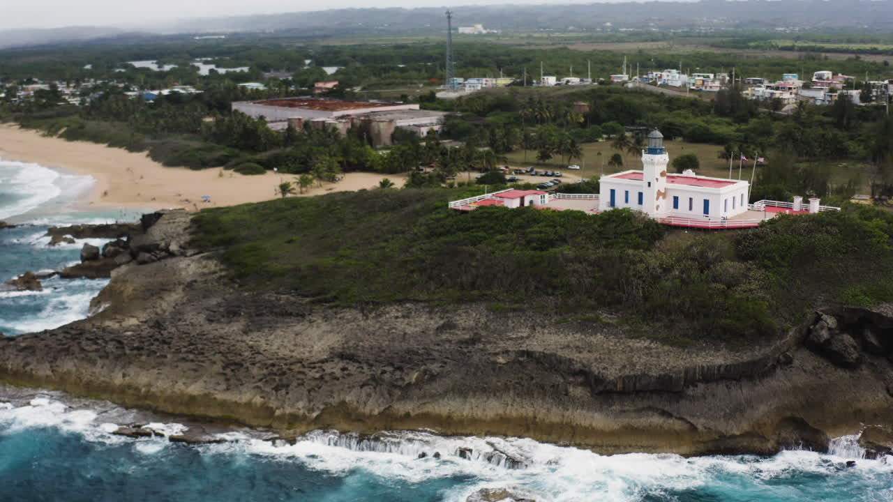 vista aérea del faro de arecibo y la idílica playa de la poza del obispo en arecibo, puerto rico - toma de drones