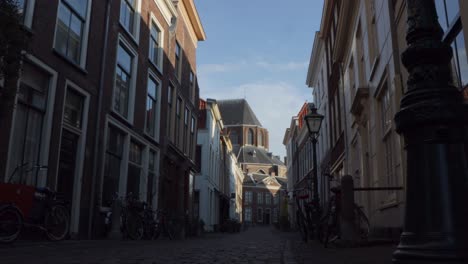 Slider-shot-of-cobbled-street-and-ancient-church-in-historical-city-in-the-Netherlands