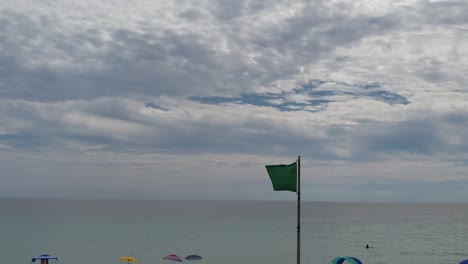 Green-flag-flying-over-the-clear-water-of-the-Gulf-of-Mexico