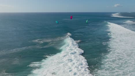 kitesurfers riding waves at one eye mauritius