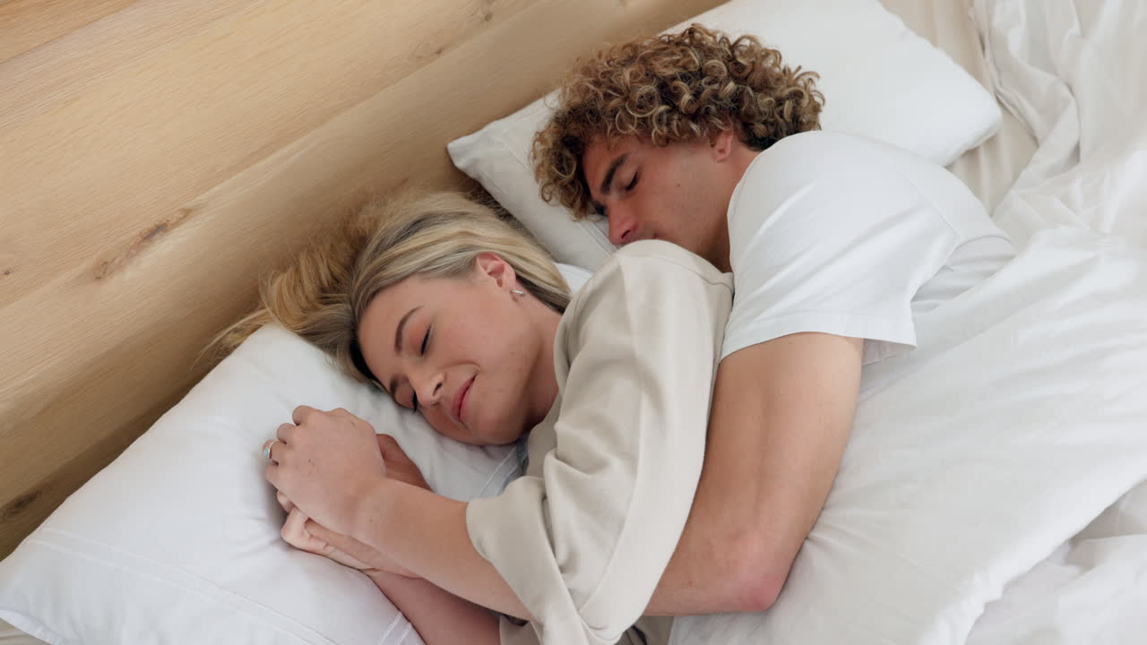 Couple sleeping together in bed with love
