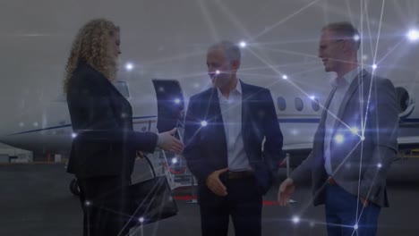 animation of networks of connections over multiple business people shaking hands at airport