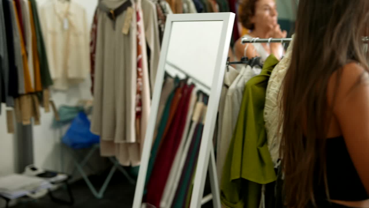 Woman browsing clothes on a clothing rack