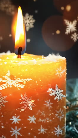 a candle is lit on a table with pine cones and snow. the scene is warm and cozy, with the candle providing a soft glow that contrasts with the cold, snowy background