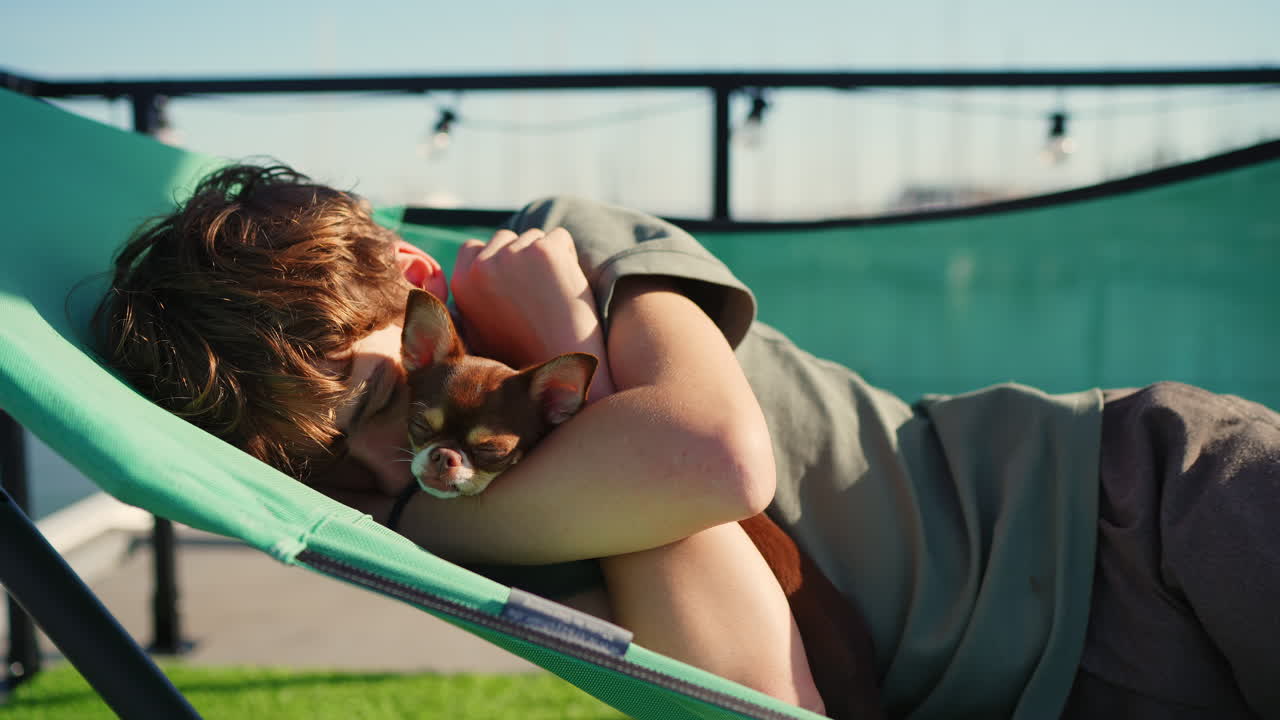 Young Person and Chihuahua Dog Sleeping Peacefully in Hammock