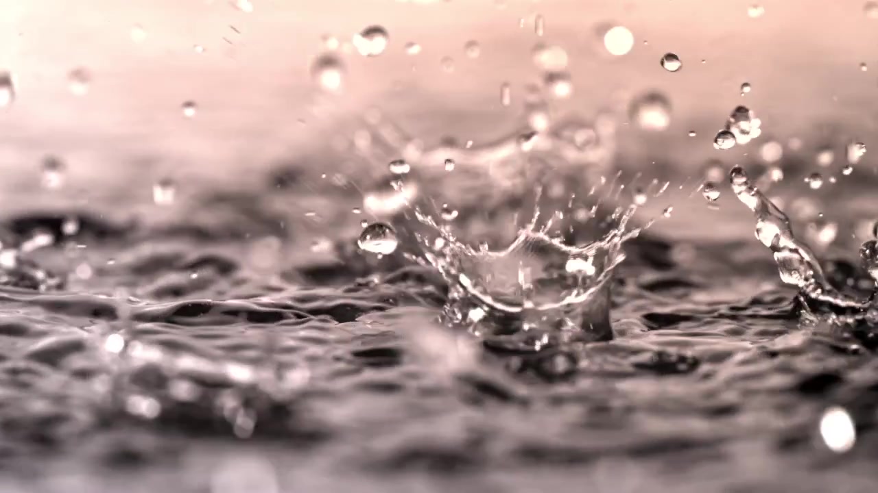 Slow Motion Raindrops Splashing on Water Surface